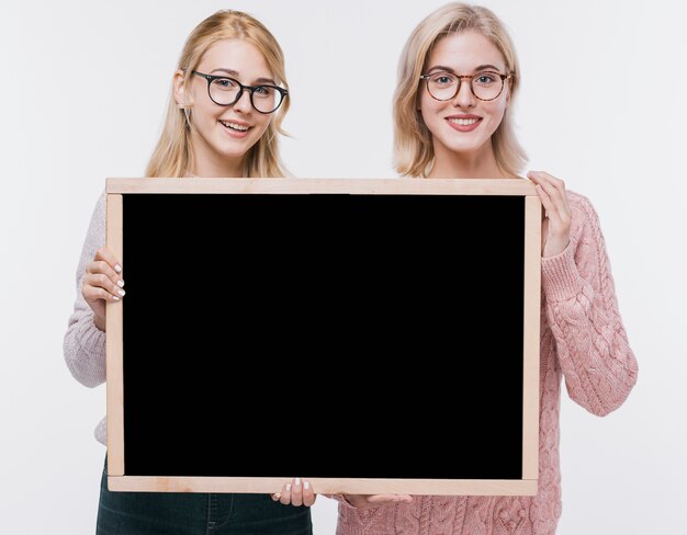 Beautiful young girls together with mock-up