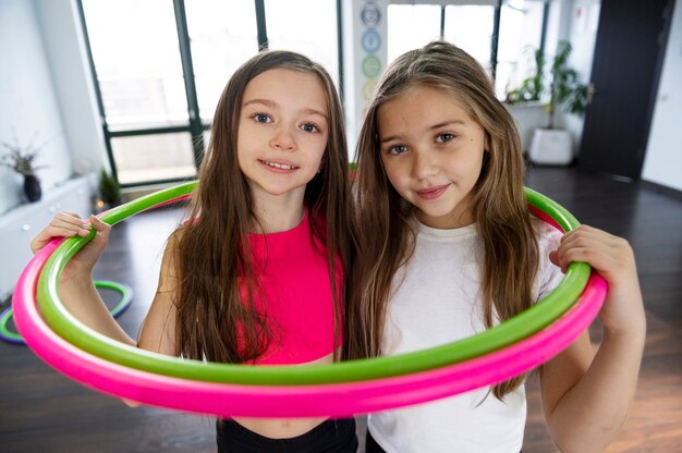 Beautiful young girls using hula hop