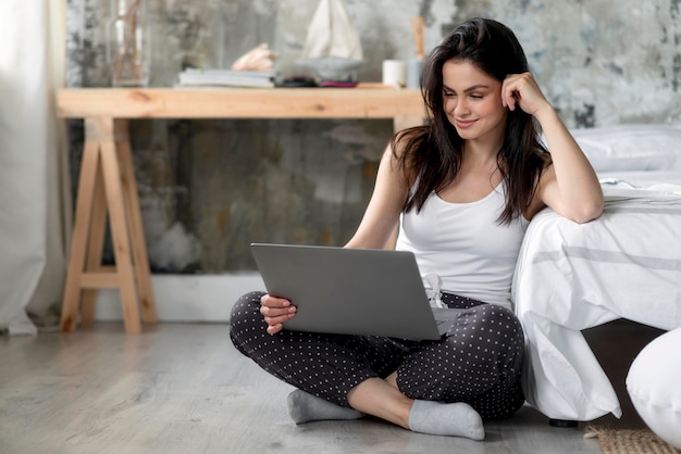 Beautiful young woman browsing laptop