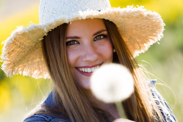 Beautiful young woman enjoying spring in a field.