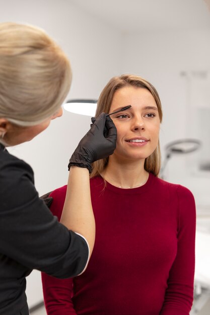 Beautiful young woman going through a microblading treatment