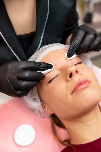 Beautiful young woman going through a microblading treatment