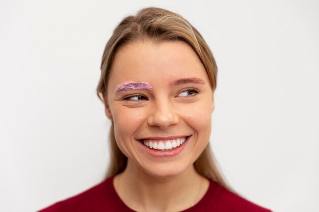 Beautiful young woman going through a microblading treatment