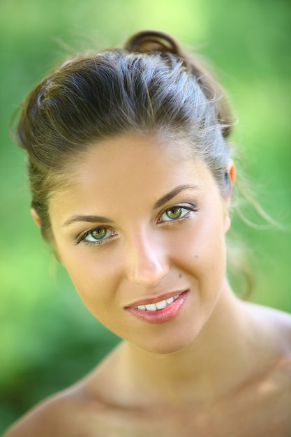 Beautiful young woman on a green background