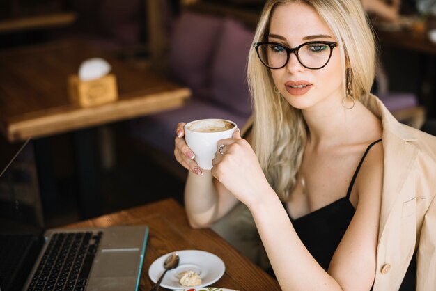 Beautiful young woman holding coffee cup