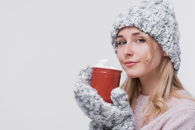 Beautiful young woman holding mug