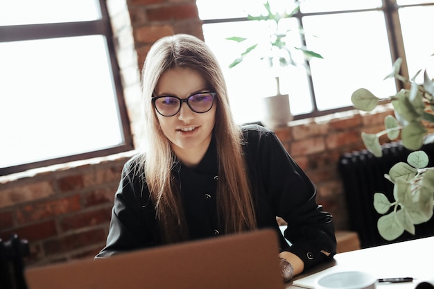 Beautiful young woman in the home office. Working from home. Teleworking concept