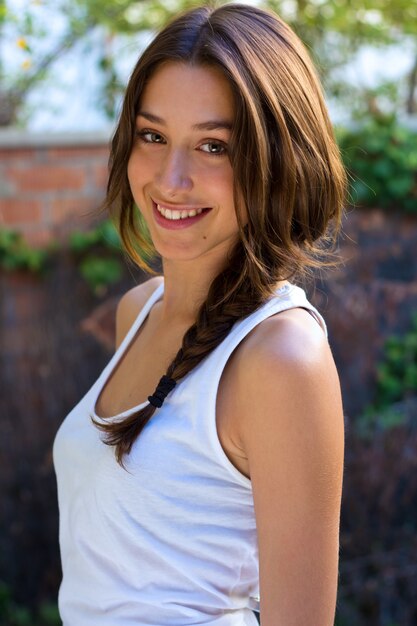 Beautiful young woman looking at camera at home.