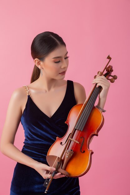 Beautiful young woman playing violin 