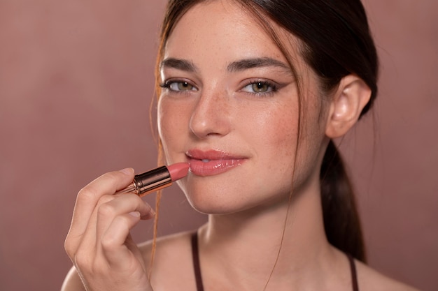 Free Photo beautiful young woman portrait with a make-up product