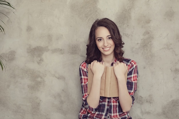 Beautiful young woman posing with book