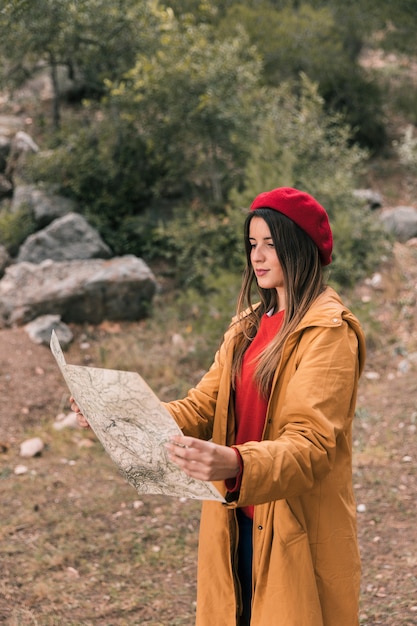 Free Photo beautiful young woman reading the map