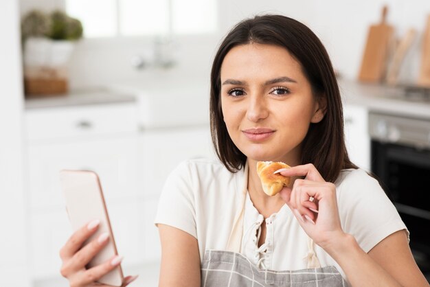 Beautiful young woman ready to eat croissant