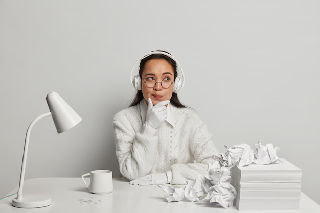 Beautiful young woman studying at her desk