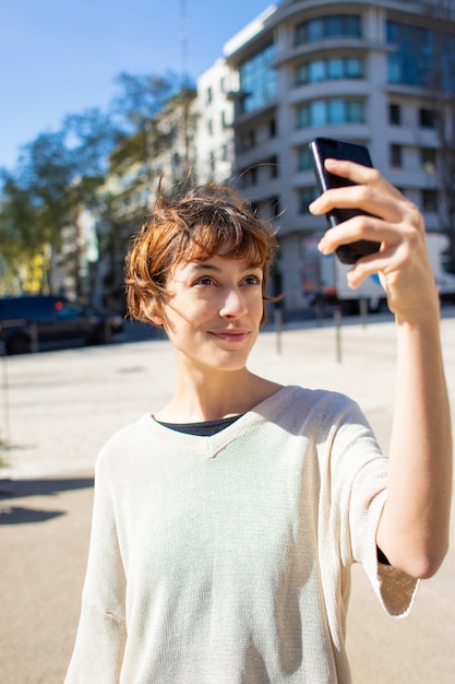 Free Photo beautiful young woman taking selfie with smartphone