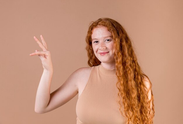 Beautiful young woman teaching sign language