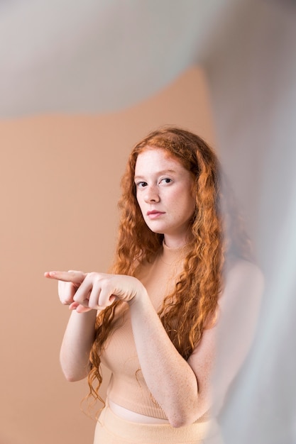 Beautiful young woman teaching sign language