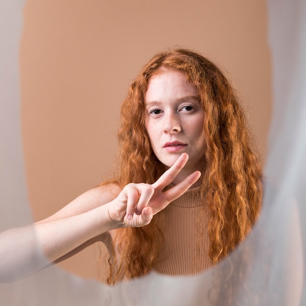 Beautiful young woman teaching sign language