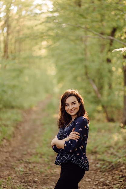 A beautiful young woman walking in the forest