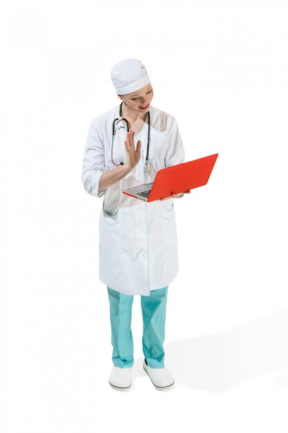 Beautiful young woman in white coat posing