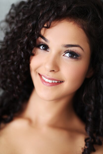 Beautiful young woman with black curly hair