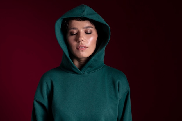 Beautiful young woman with closed eyes wearing a hoodie