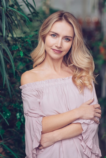 Beautiful young woman with crossed arms looking at camera