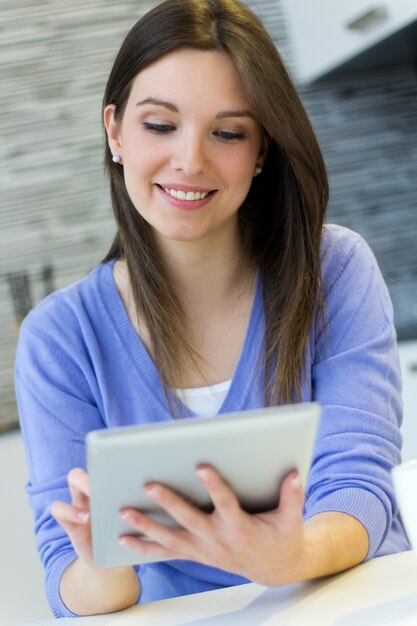 Beautiful young woman with digital tablet