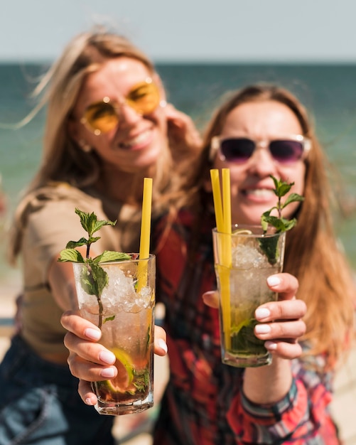 Free Photo beautiful young women enjoying summer cocktails