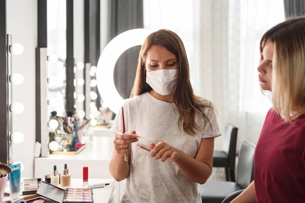 Free photo beauty adviser showing products to the client