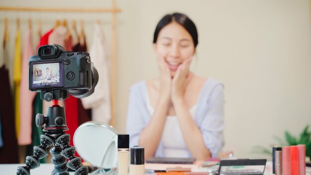 Beauty blogger present beauty cosmetics sitting in front camera for recording video. 