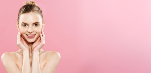 Free photo beauty concept beautiful caucasian woman with clean skin natural makeup isolated on bright pink background with copy space