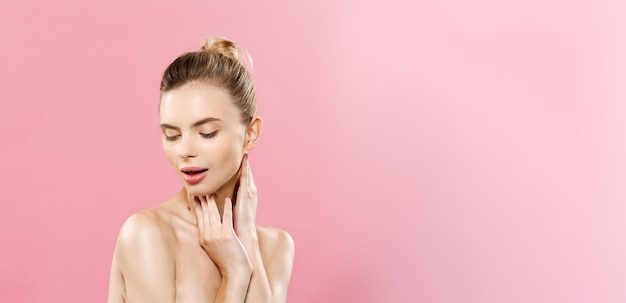 Beauty Concept Beautiful Caucasian woman with clean skin natural makeup isolated on bright pink background with copy space