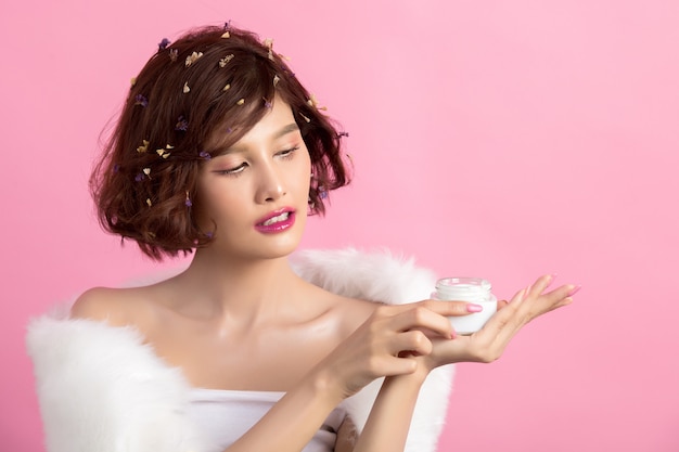 Free photo beauty concept. woman holds a moisturizer in her hand