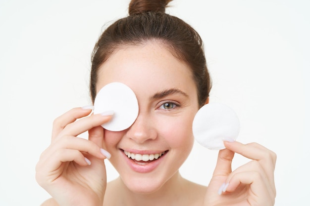 Free Photo beauty and female concept close up portrait young woman holding cotton cosmetic pads near her face