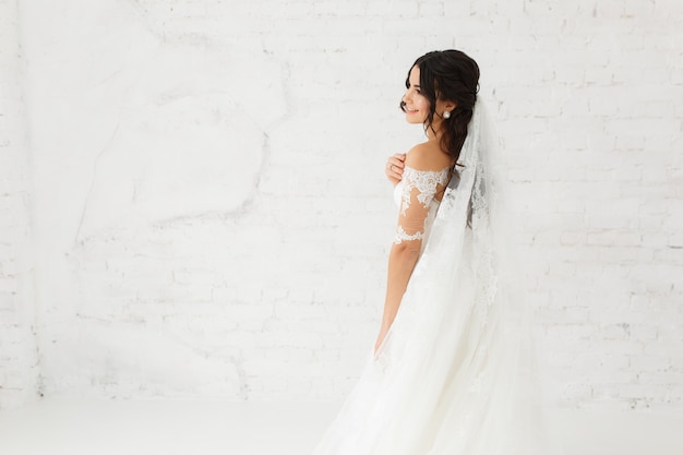 Beauty portrait of bride wearing fashion wedding dress with feathers