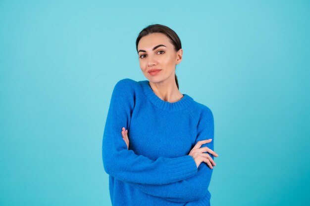 Beauty portrait young woman in a blue knitted sweater and natural day makeup, smiling cheerfully, confident romantic smile