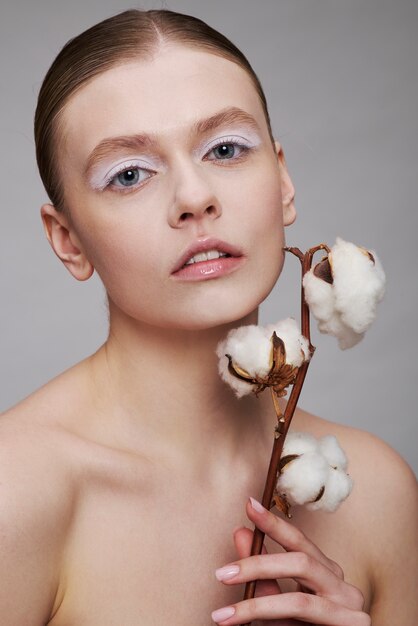 Beauty portrait of young woman with plant