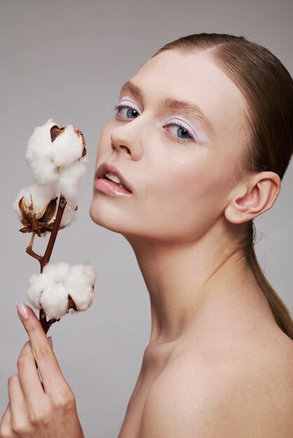 Beauty portrait of young woman with plant