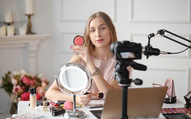 Beauty vlogger. Young woman recording a makeup tutorial