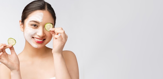 Beauty young asian women skin care image with cucumber on white background studio