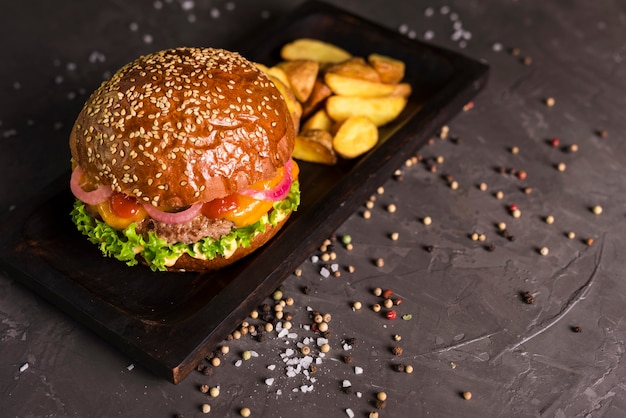 Free photo beef burger with french fries on a table