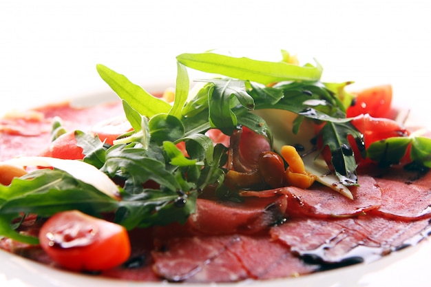 Beef carpaccio served with ruccola 