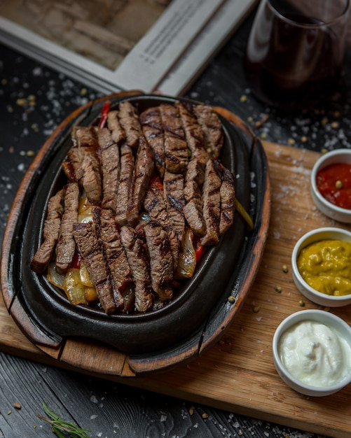 Beef fajitas in mexican style inside plack pan