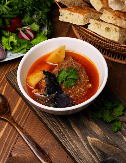 Beef, lamb stew, bosbash soup with potatoes, basilic and parsley in tomato sauce.