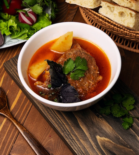 Beef, lamb stew, bosbash soup with potatoes, basilic and parsley in tomato sauce. 