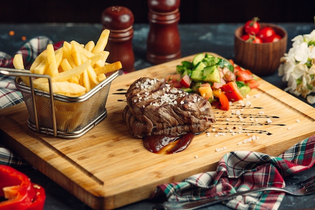 Beef steak with cherry tomato and French fries