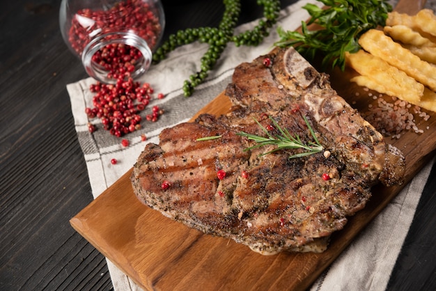 Beef steak with french fries and red pepper