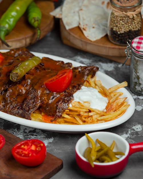 Beef steak with tomatos and fried potatoes