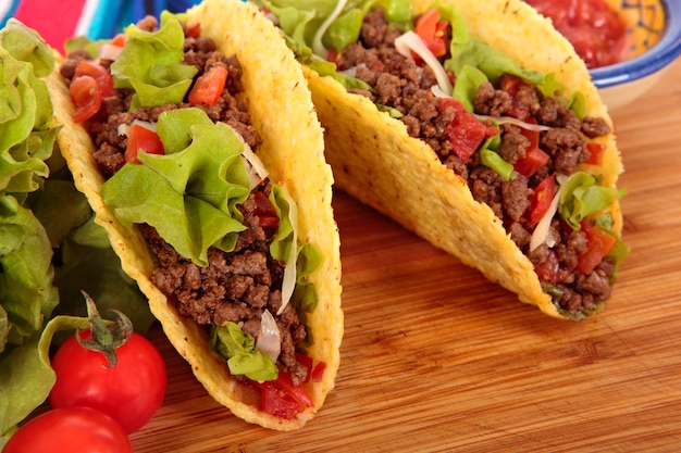 Beef tacos on wooden table 